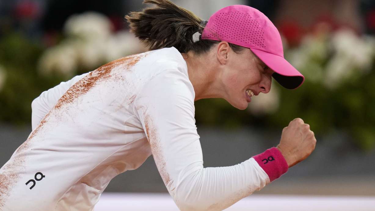 Poland's Iga Swiatek celebrates after winning the women's final match against Aryna Sabalenka of Belarus, at the Mutua Madrid Open tennis tournament in Madrid, Spain, Saturday, May 4, 2024.