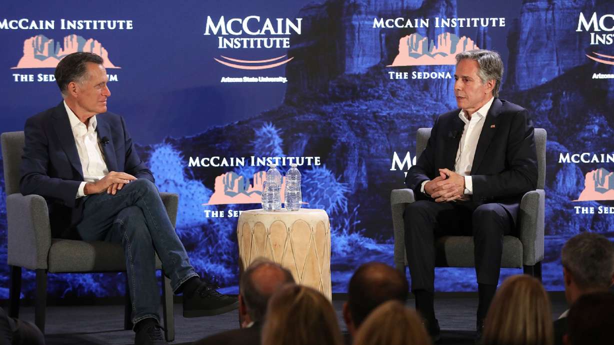 Utah Republican Sen. Mitt Romney, left, listens to U.S. Secretary of State Antony Blinken talk about his recent trip to the Middle East, at the McCain Institute's Sedona Forum in Sedona, Ariz., Friday.