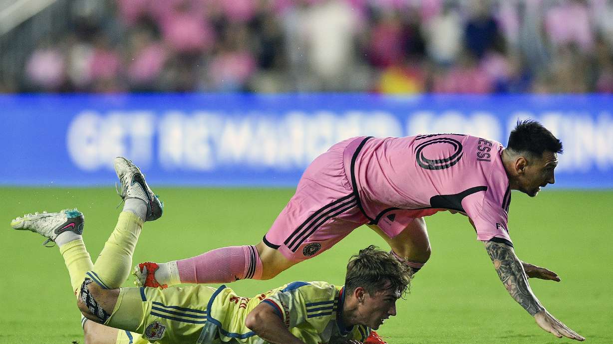 Inter Miami forward Lionel Messi falls on New York Red Bulls midfielder Daniel Edelman during the first half of an MLS soccer game, Saturday, May 4, 2024, in Fort Lauderdale, Fla.