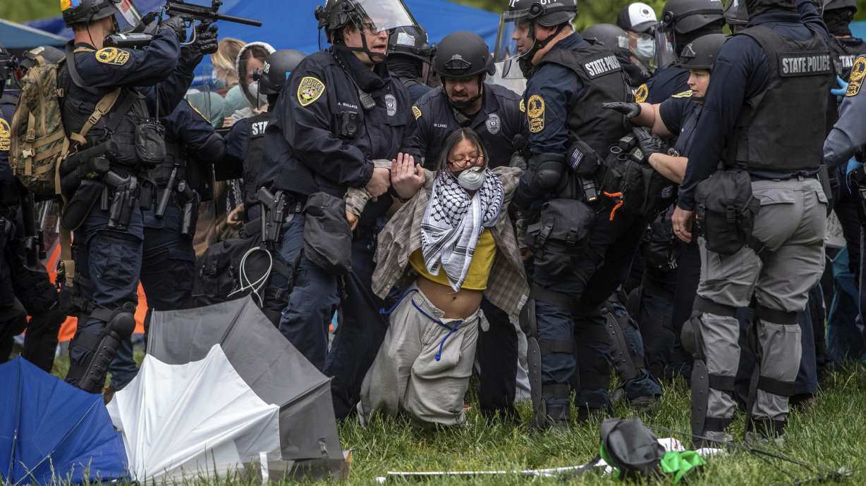 Police lift a pro-Palestinian demonstrator from the ground on the University of Virginia campus, in Charlottesville, Va., where tents are set up, Saturday.