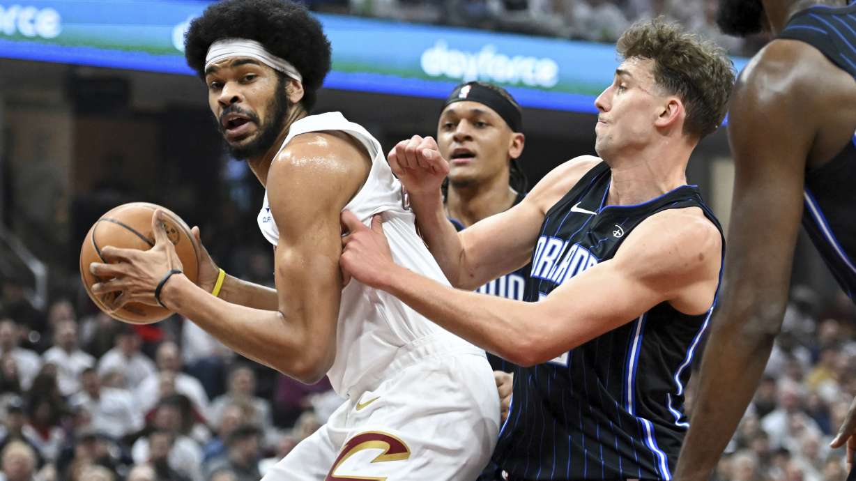 Cleveland Cavaliers' Jarrett Allen drives against Orlando Magic's Franz Wagner during the first half in Game 1 of an NBA basketball first-round playoff series, Saturday, April 20, 2024, in Cleveland.