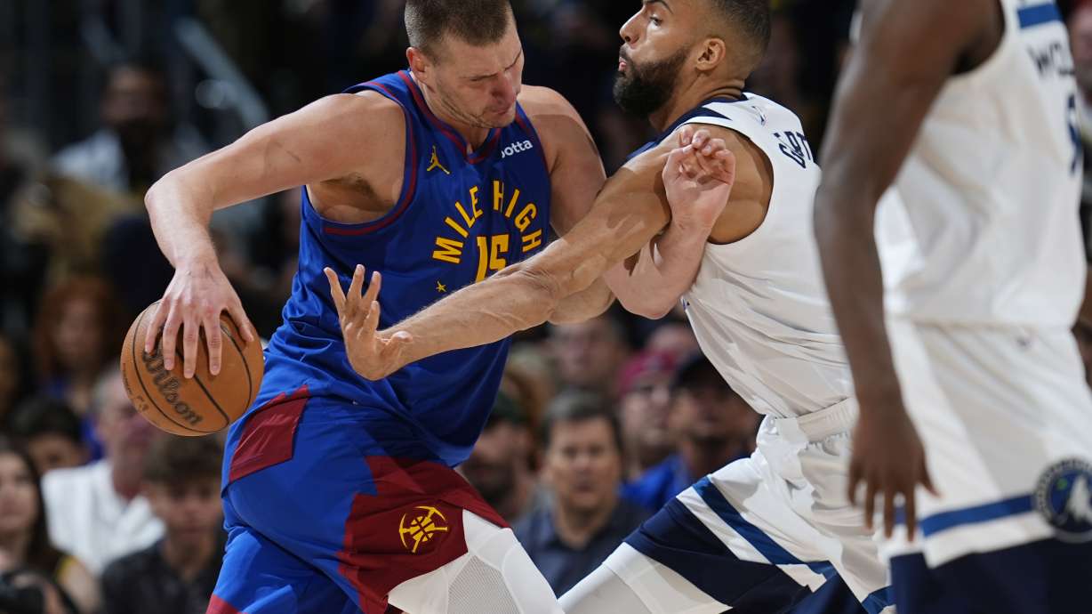 Denver Nuggets center Nikola Jokic, left, drives to the basket as Minnesota Timberwolves center Rudy Gobert defends in the second half of Game 1 of an NBA basketball second-round playoff series Saturday, May 4, 2024, in Denver.