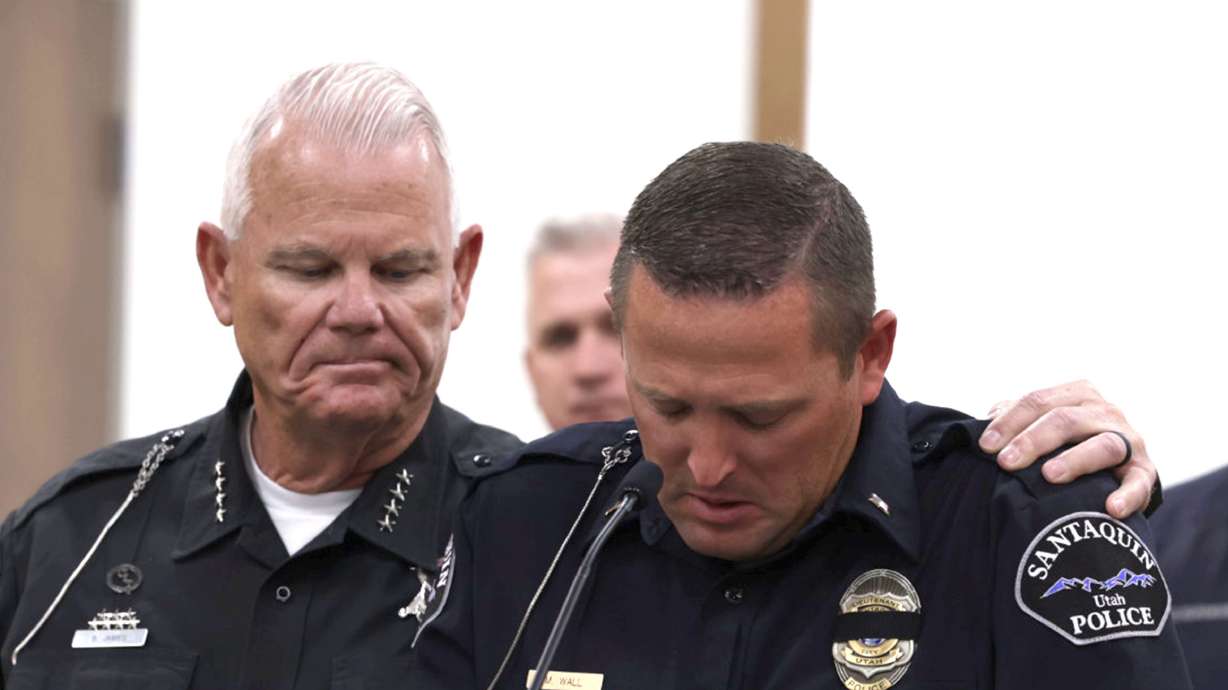 Salem Police Chief Brad James, left, puts his arm around Santaquin Police Sgt. Mike Wall during a press conference Sunday after a Santaquin police officer was hit by a vehicle and killed.