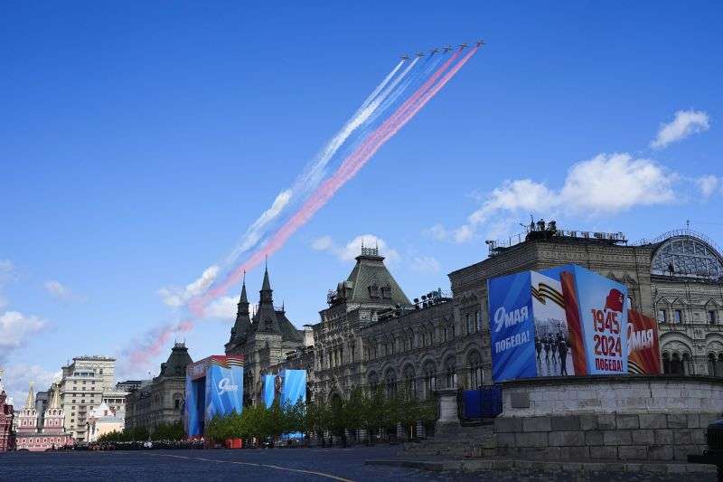 Russian military planes fly over Red Square leaving trails of smoke in colors of the national flag during the Victory Day military parade dress rehearsal at the Red Square in Moscow, Russia, Sunday.