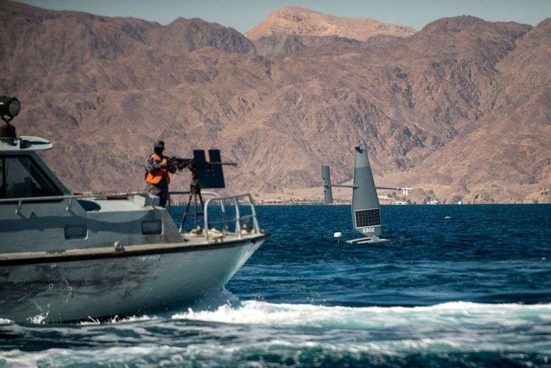 A Saildrone Explorer unmanned surface vessel sails by a Royal Jordanian Navy patrol craft conducting counter-illegal fishing training during a 60-nation International Maritime Exercise in the Gulf of Aqaba, Jordan, Feb. 9, 2022.