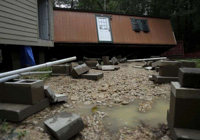 Dorothy and Earl Blevins' temporary home sits off its foundation after it was moved by flooded water and into the new home they are building on property once owned by Dorothy's mother on Sunday, in Spendora, Texas.