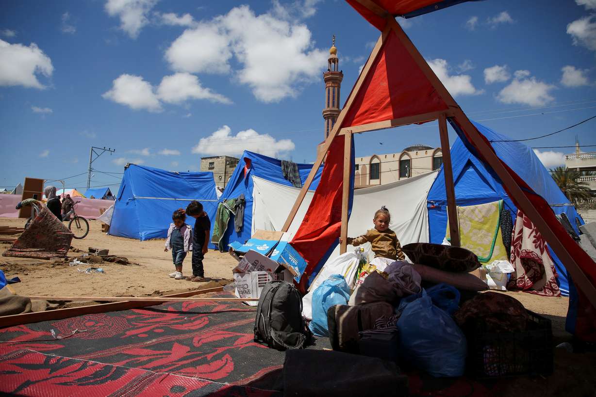 A child looks on as displaced people dismantle their tents after the Israeli military began evacuating Palestinian civilians ahead of a threatened assault on Rafah, amid the ongoing conflict between Israel and Hamas, in Rafah, in the southern Gaza Strip Monday.
