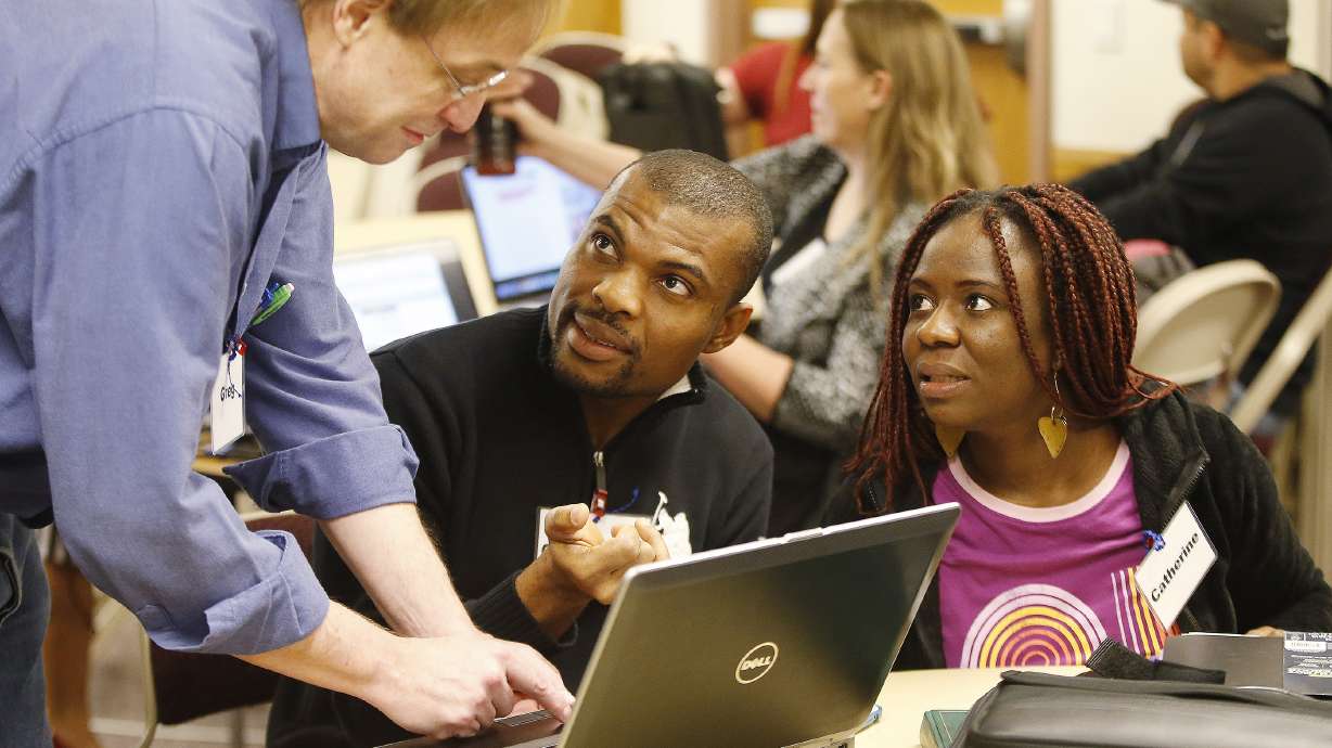 Christopher and Catherine Anoruo get some help from fellow student Greg Church in the BYU-Pathway Worldwide program in Orem on Feb 16, 2017. Last month, the program began offering three-year bachelor's degree programs for the first time, through BYU-Idaho and Ensign College.