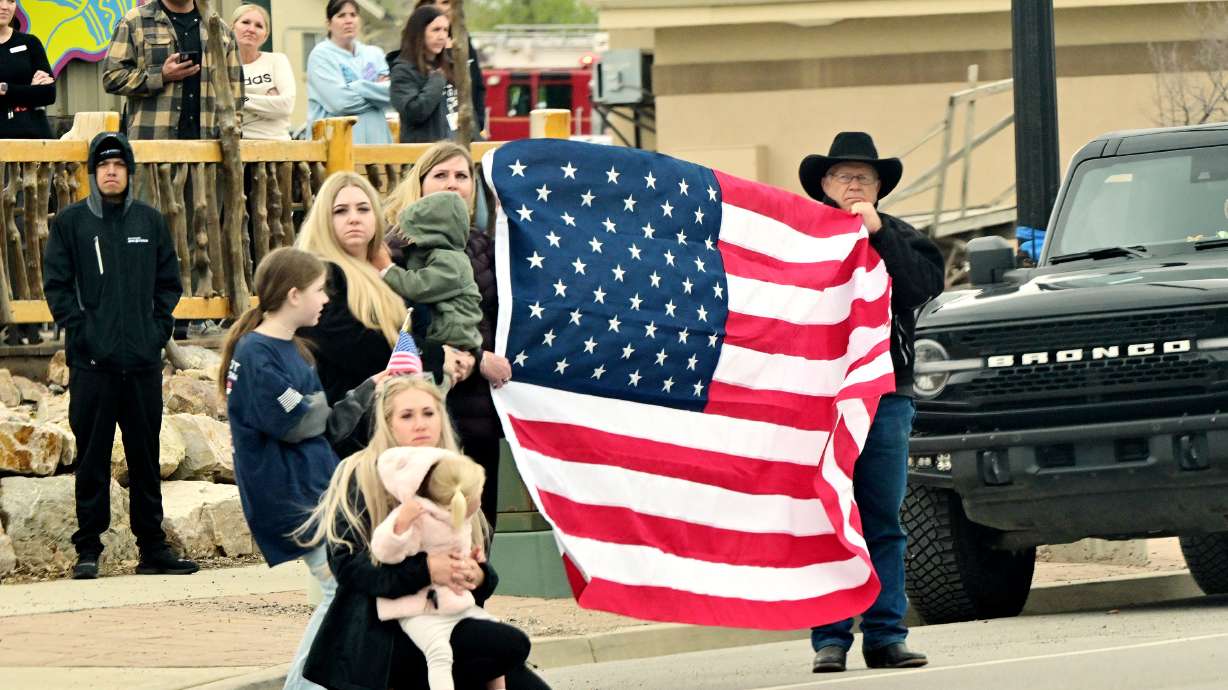 Santaquin residents watch the procession bringing Santaquin Police Sgt. Bill Hooser to Santaquin from the medical examiner's office in Taylorsville on Monday. Hooser's funeral will be held on May 13, the state announced.