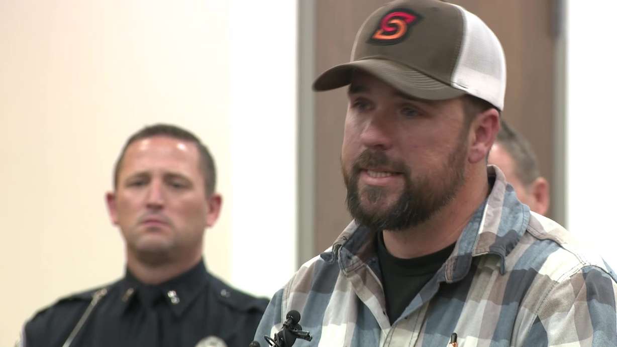 Mike Hooser speaks at a press conference with other local law enforcement.