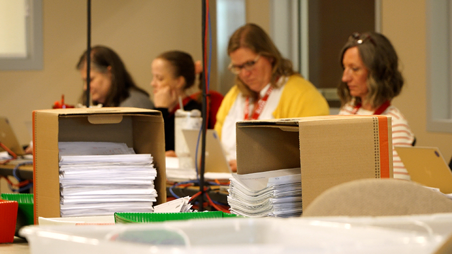 Employees in Davis County’s election center review voter signatures for certification in this undated photo.