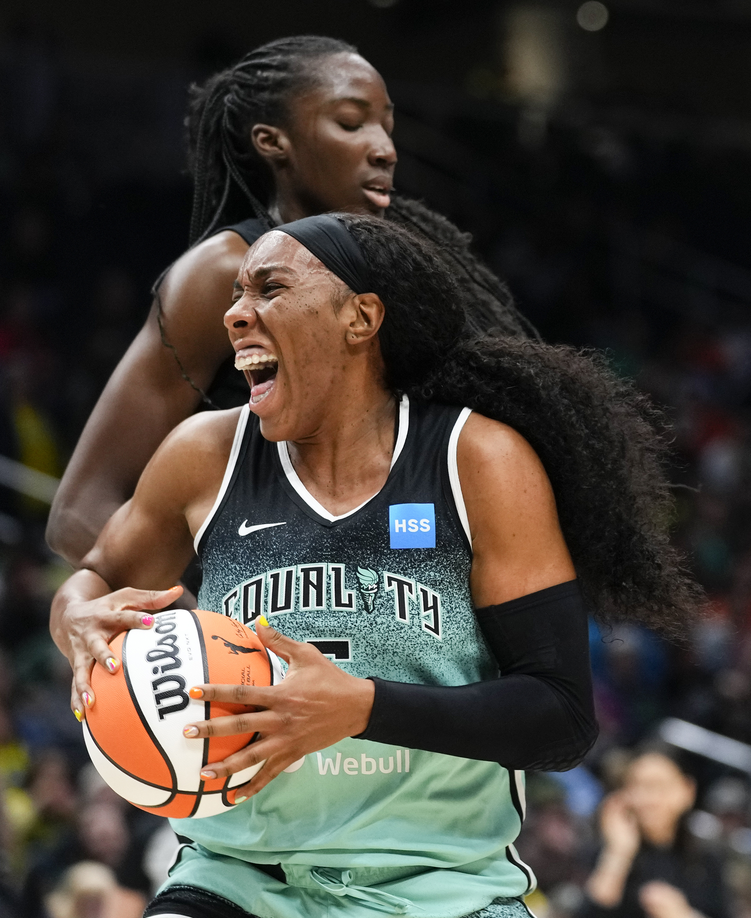 FILE - New York Liberty forward Kayla Thornton, bottom, reacts in front of Seattle Storm center Ezi Magbegor, top, as a jump ball is called during the first half of a WNBA basketball game May 30, 2023, in Seattle. Two WNBA players were among a dozen Americans that opted to play in Russia this past offseason, a decision Thornton said raised a few eyebrows following Brittney Griner’s incarceration in 2022.