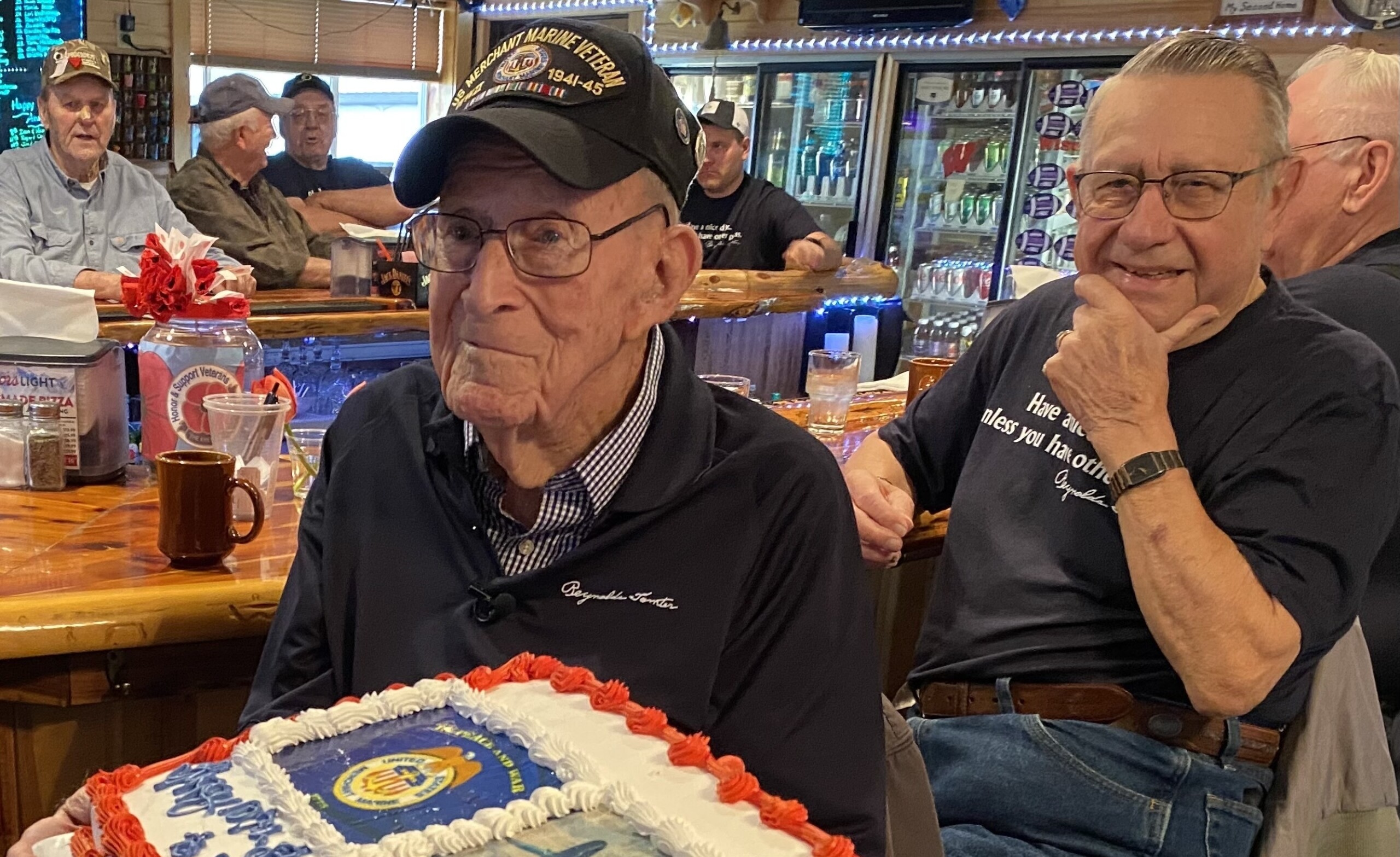 Reynolds Tomter gets a peek at his birthday cake in an undated photo in Pigeon Falls, Wis. Tomter, 107, has been invited to attend the 80th anniversary of the D-Day landings in Normandy, France.