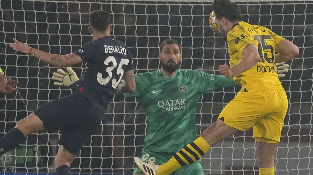 Dortmund's Mats Hummels, right, scores his side's opening goal during the Champions League semifinal second leg soccer match between Paris Saint-Germain and Borussia Dortmund at the Parc des Princes stadium in Paris, France, Tuesday, May 7, 2024.
