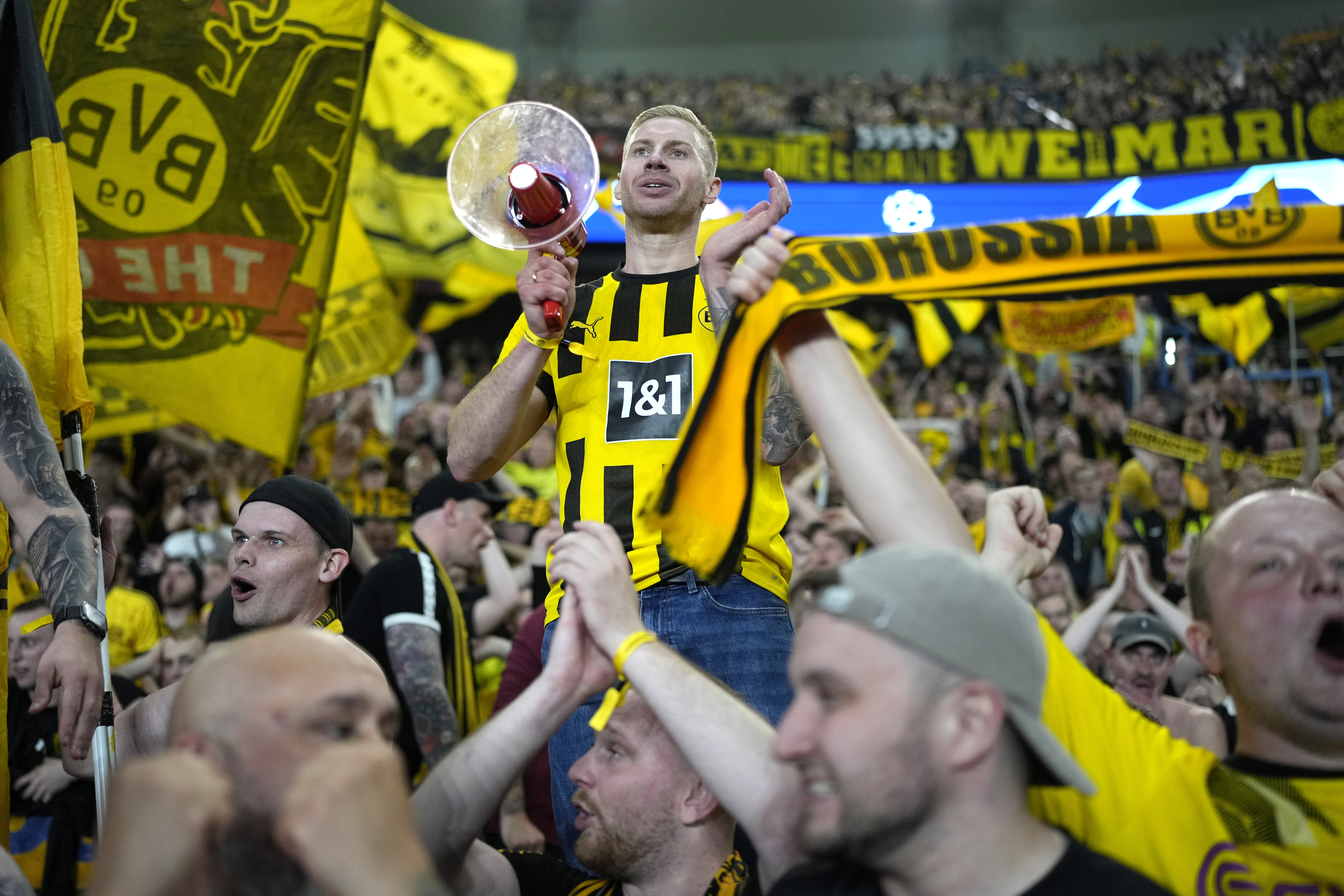 Borussia Dortmund supporters celebrate at the end of the Champions League semifinal second leg soccer match between Paris Saint-Germain and Borussia Dortmund at the Parc des Princes stadium in Paris, France, Tuesday, May 7, 2024.