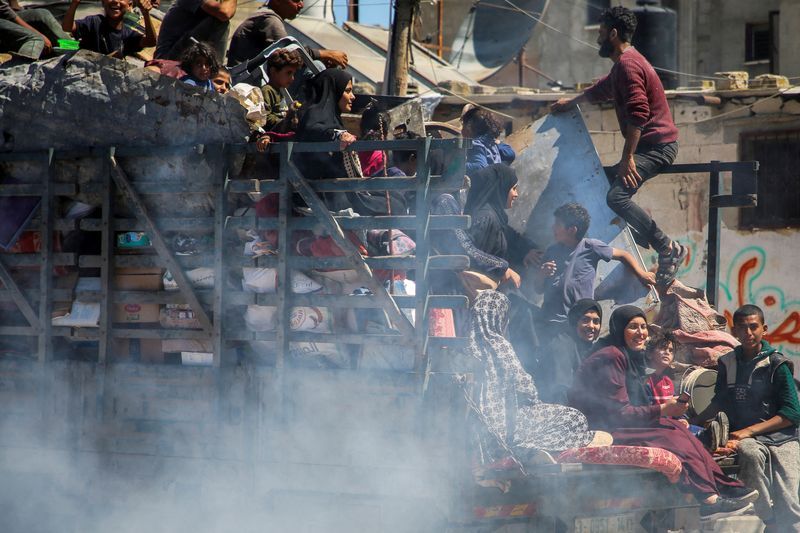 Palestinians travel in a truck as they flee Rafah after Israeli forces launched a ground and air operation in the eastern part of the southern Gaza city, amid the ongoing conflict between Israel and Hamas, in Rafah, in the southern Gaza Strip Wednesday.