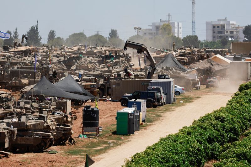 Israeli military vehicles are seen near the Israel-Gaza border, amid the ongoing conflict between Israel and the Palestinian Islamist group Hamas, in southern Israel, Wednesday.
