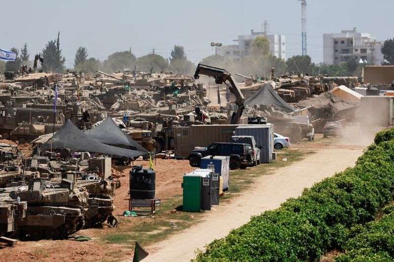Israeli military vehicles are seen near the Israel-Gaza border, amid the ongoing conflict between Israel and the Palestinian Islamist group Hamas, in southern Israel, Wednesday.
