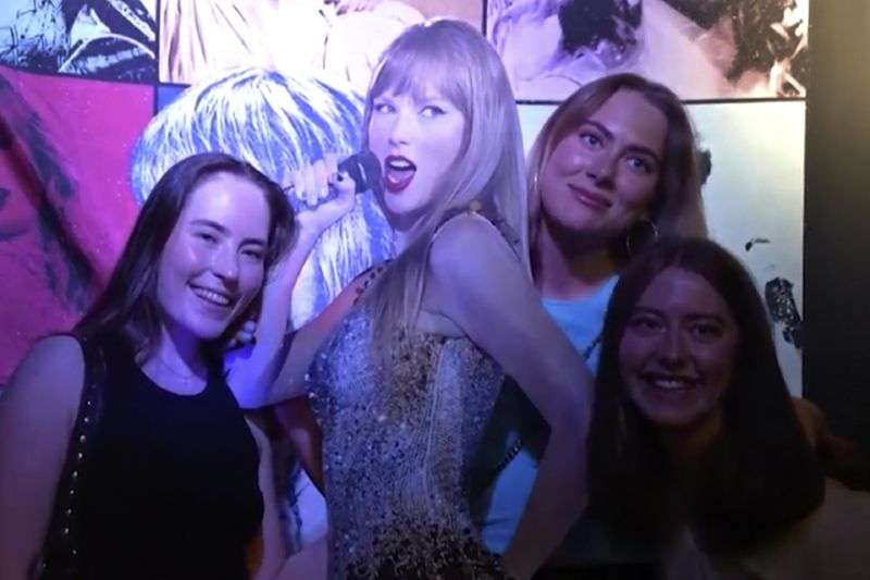 Fans pose with a life-size image of Taylor Swift at a club that plays only Swift's music in Gothenburg, Sweden, on April 30.