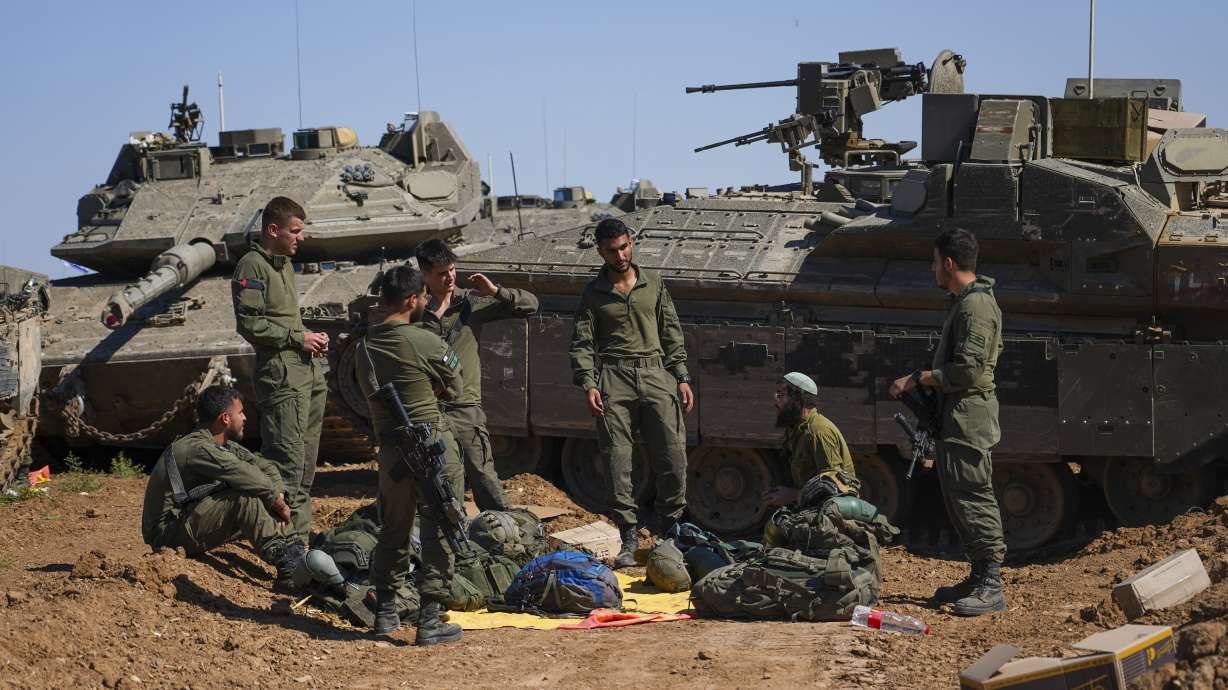 Israeli soldiers work on armored military vehicles at a staging ground near the Israeli-Gaza border, in southern Israel, May 8. Utah Sens. Mike Lee and Mitt Romney have criticized the White House over its decision to withhold some military aid to Israel.