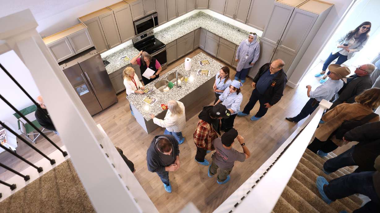 Canyons Technical Education Center students and guests look over the home they built in Sandy on Wednesday. Marie Willson and her Canyons Technical Education Center classmates spent 10 to 12 hours a week constructing the 1,900-square-foot house.