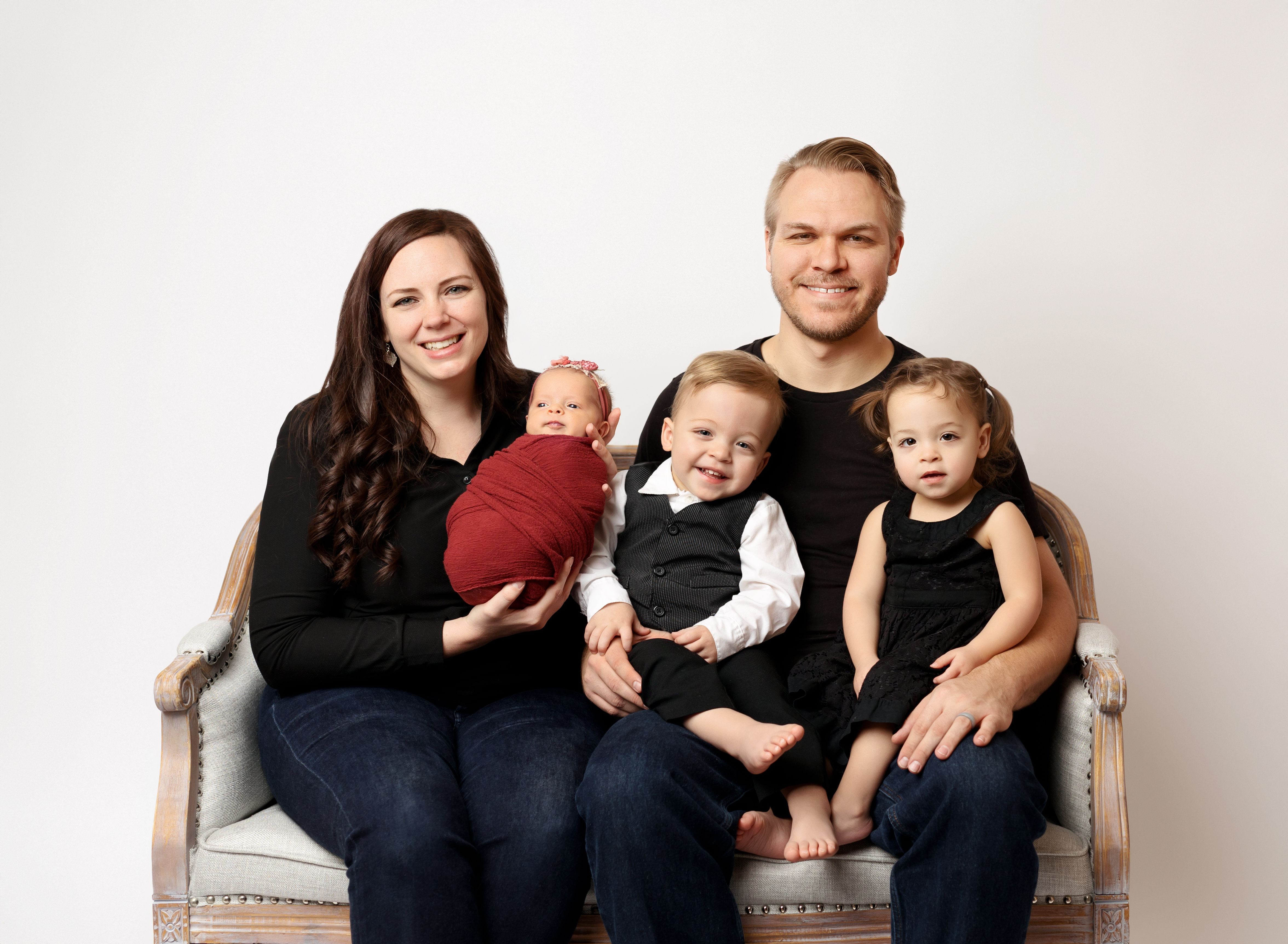 Pete and Lindsey Rakozy are pictured with their three children in this undated photo. The family was displaced from their home due to a fire on Sunday.
