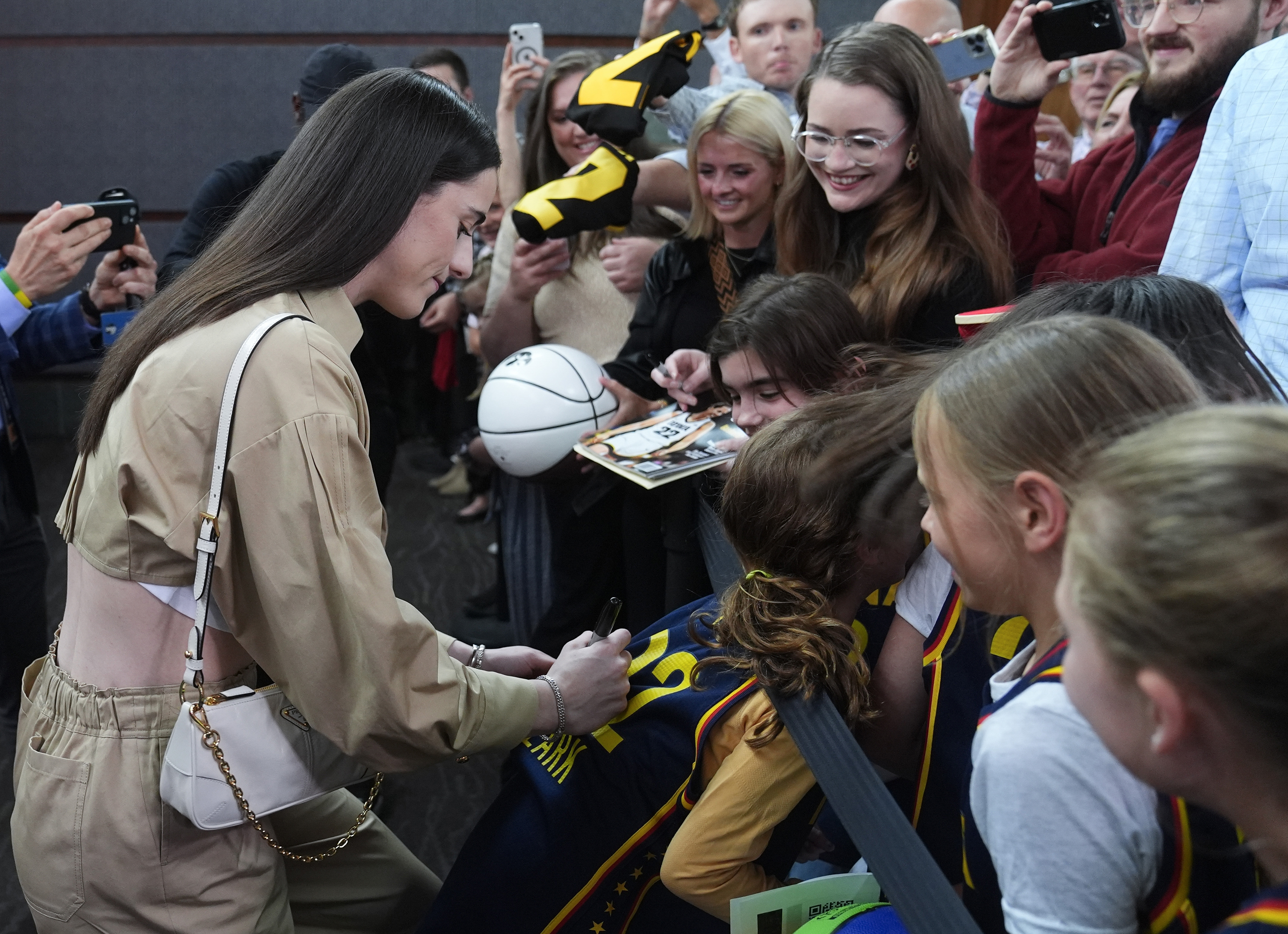 Indiana Fever's Caitlin Clark, left, gives autographs as she arrives on the Red Carpet before the world premiere and screening of Episode 1 of the upcoming ESPN+ Original Series Full Court Press, Monday, May 6, 2024, in Indianapolis.