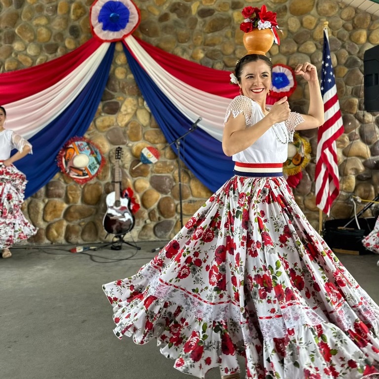 A dancer performing a traditional Paraguayan dance takes part in the 2023 Independence Day celebration for Paraguay, held in South Jordan and organized by Paraguayans in Utah, a group of expatriates from the country.