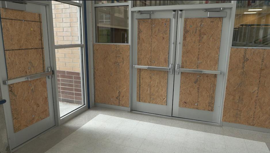 Several doors are covered up with plywood Thursday at Matheson Junior High in Magna.