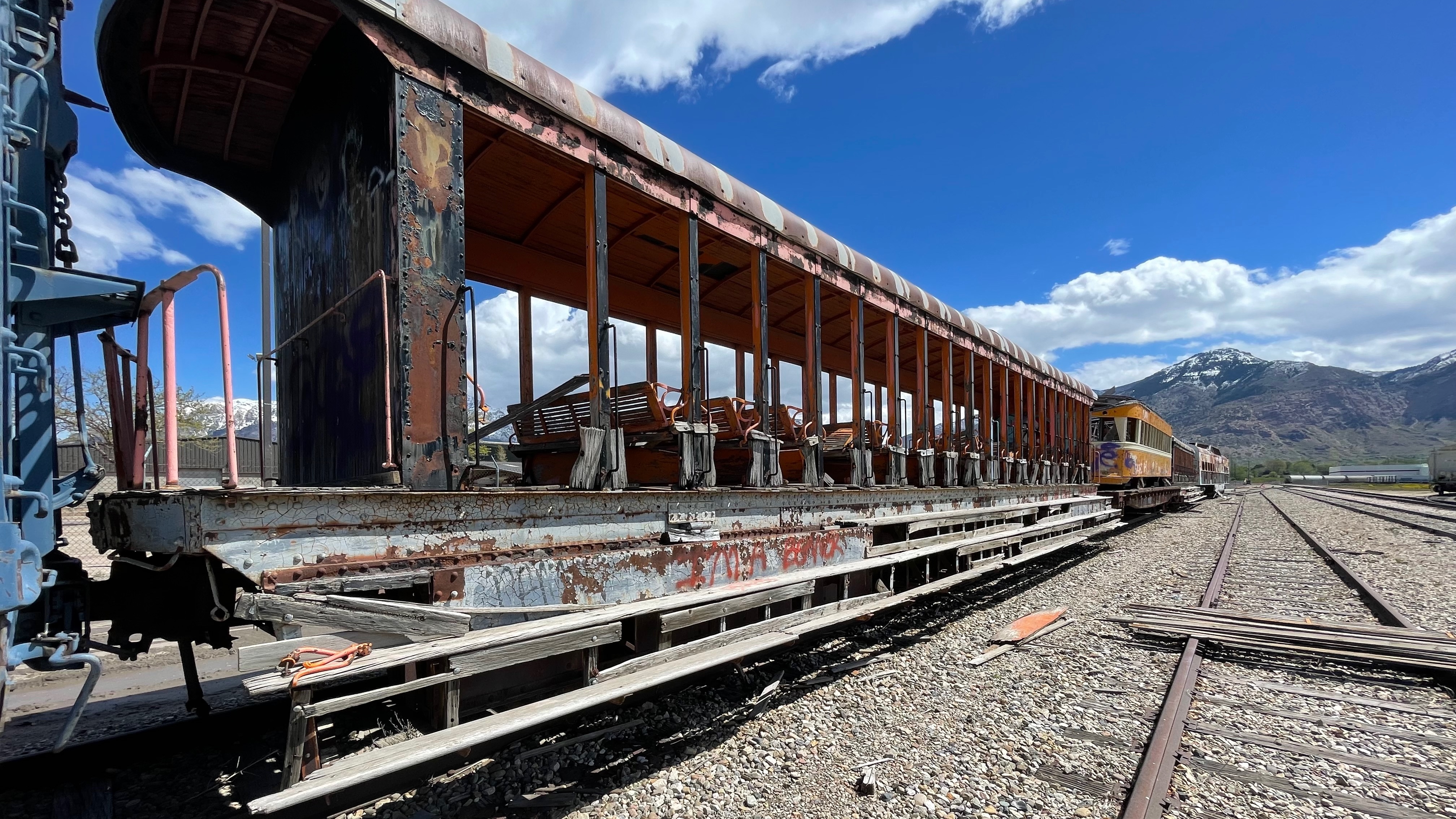 An old Saltair train car sits on the grounds of Business Depot Ogden on Friday, May 10, 2024. It's part of the collection of the Utah State Railroad Museum. An old Bamberger car sits in front of it.