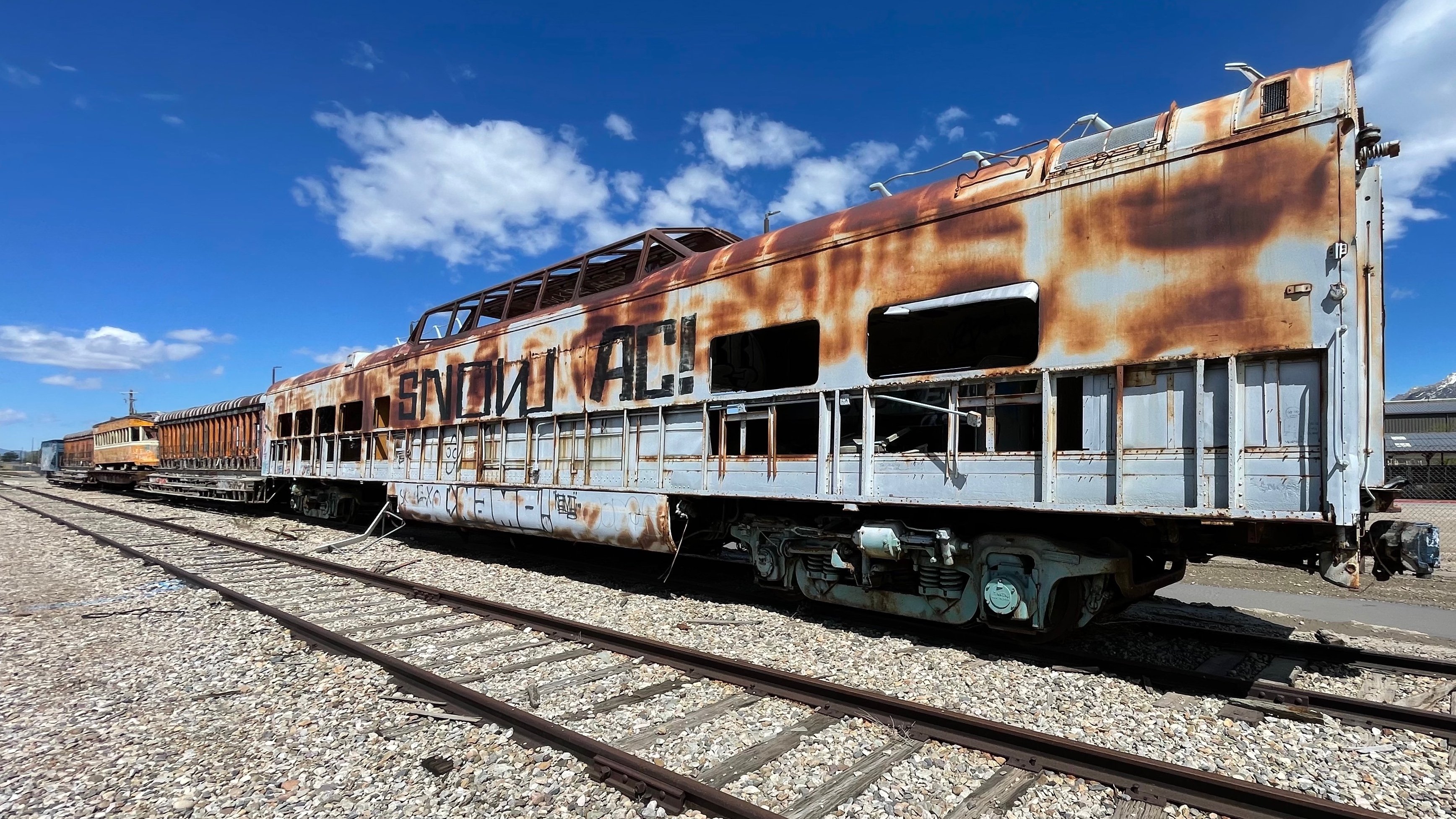 An old Moon Glow train car sits on the grounds of Business Depot Ogden on Friday, May 10, 2024. It's part of the collection of the Utah State Railroad Museum. Old Salt Air and Bamberger cars sit in front of it.