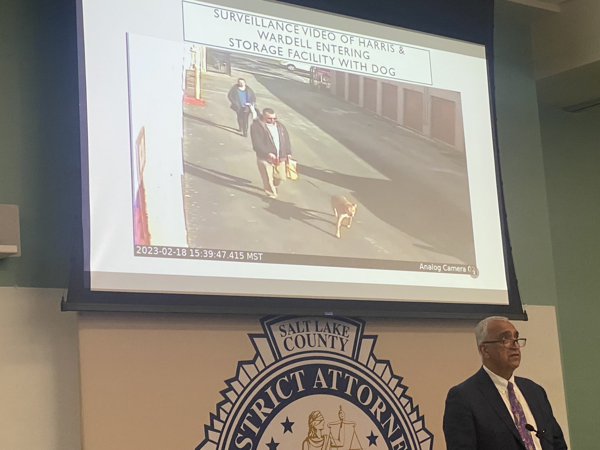 Salt Lake County Attorney Sim Gill shows surveillance video of Alexander Paul Wardell, Morgan Kay Harris and their dog walking into a storage shed in 2023 shortly before Harris was locked in the shed and died when a fire started.
