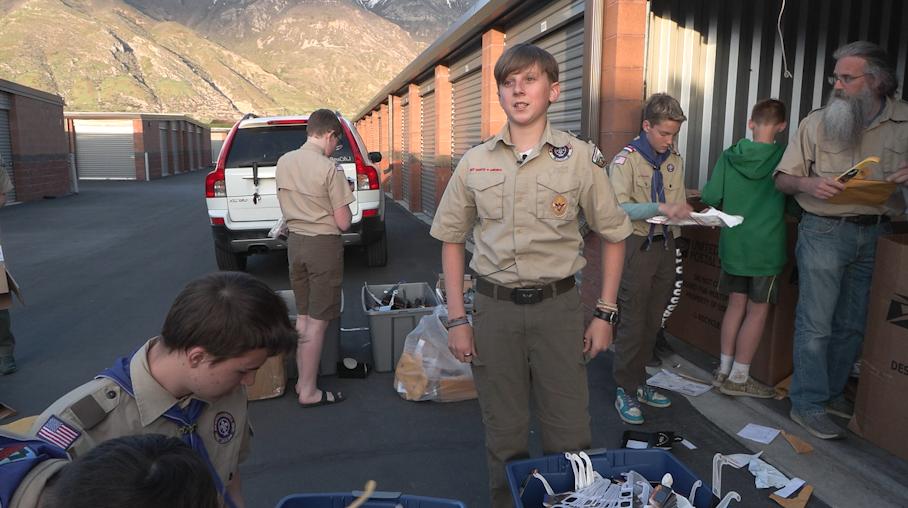 Luke Wojcik of Boy Scout Troop 37 helps sort through eclipse glasses.