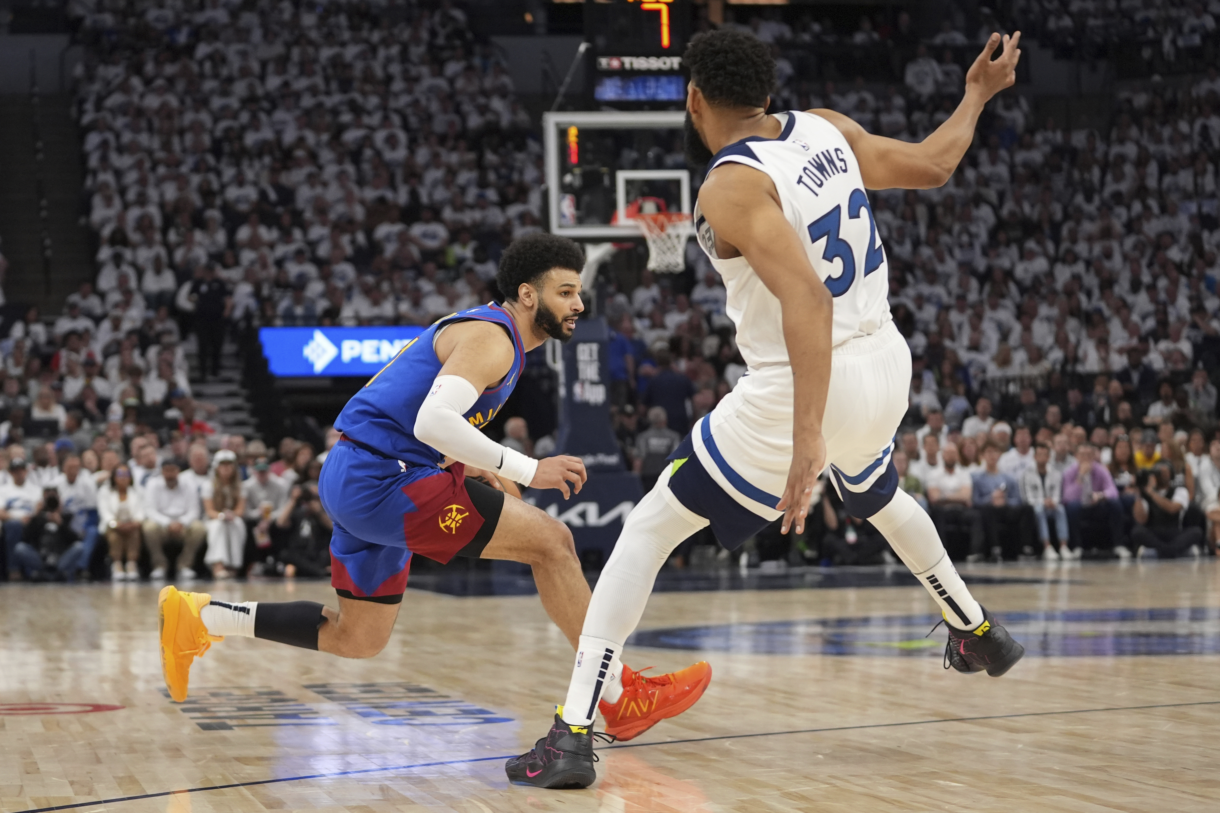Denver Nuggets guard Jamal Murray, left, works toward the basket as Minnesota Timberwolves center Karl-Anthony Towns (32) defends during the first half of Game 3 of an NBA basketball second-round playoff series, Friday, May 10, 2024, in Minneapolis.