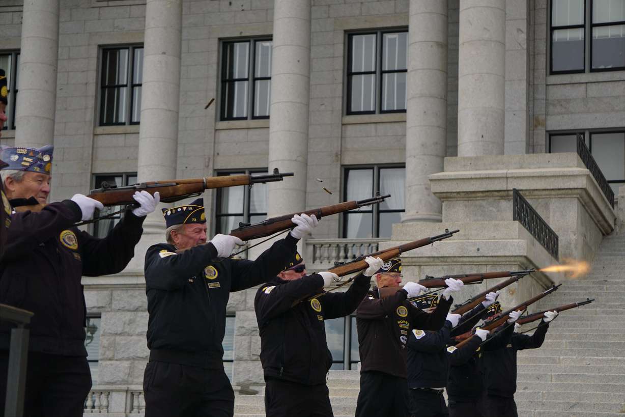 Honor guard veterans fire a 21-gun salute on the south lawn of the state Capitol in Salt Lake City on Friday.