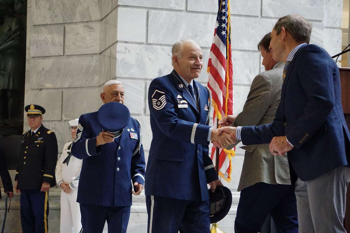 Rep. John Curtis and Keven Stratton give honor guard veterans awards at the state Capitol in Salt Lake City on Friday for providing military honors at over 100 funerals.