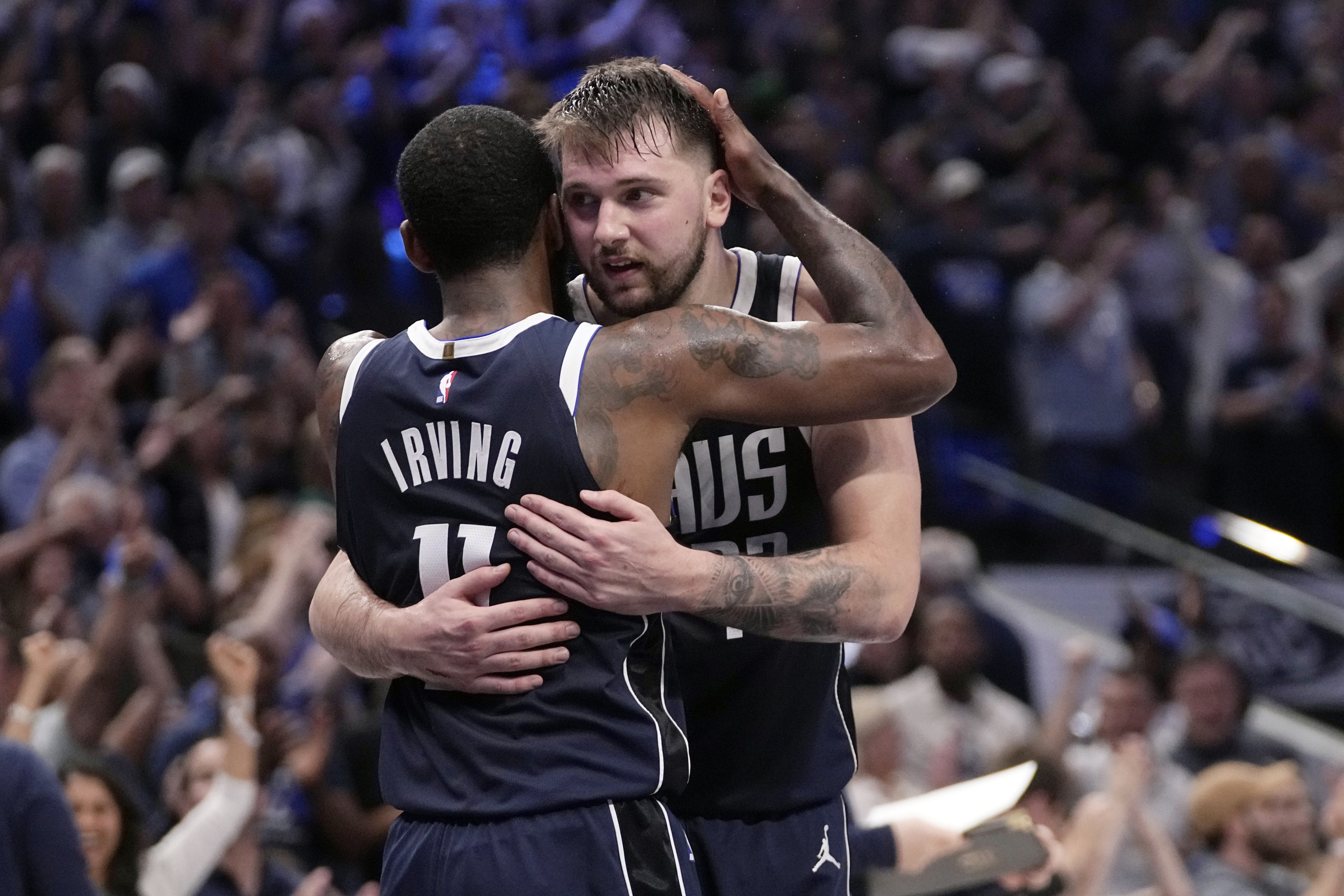 Dallas Mavericks' Kyrie Irving (11) and Luka Doncic, right, celebrate the team's win in Game 3 of an NBA basketball second-round playoff series against the Oklahoma City Thunder, Saturday, May 11, 2024, in Dallas.