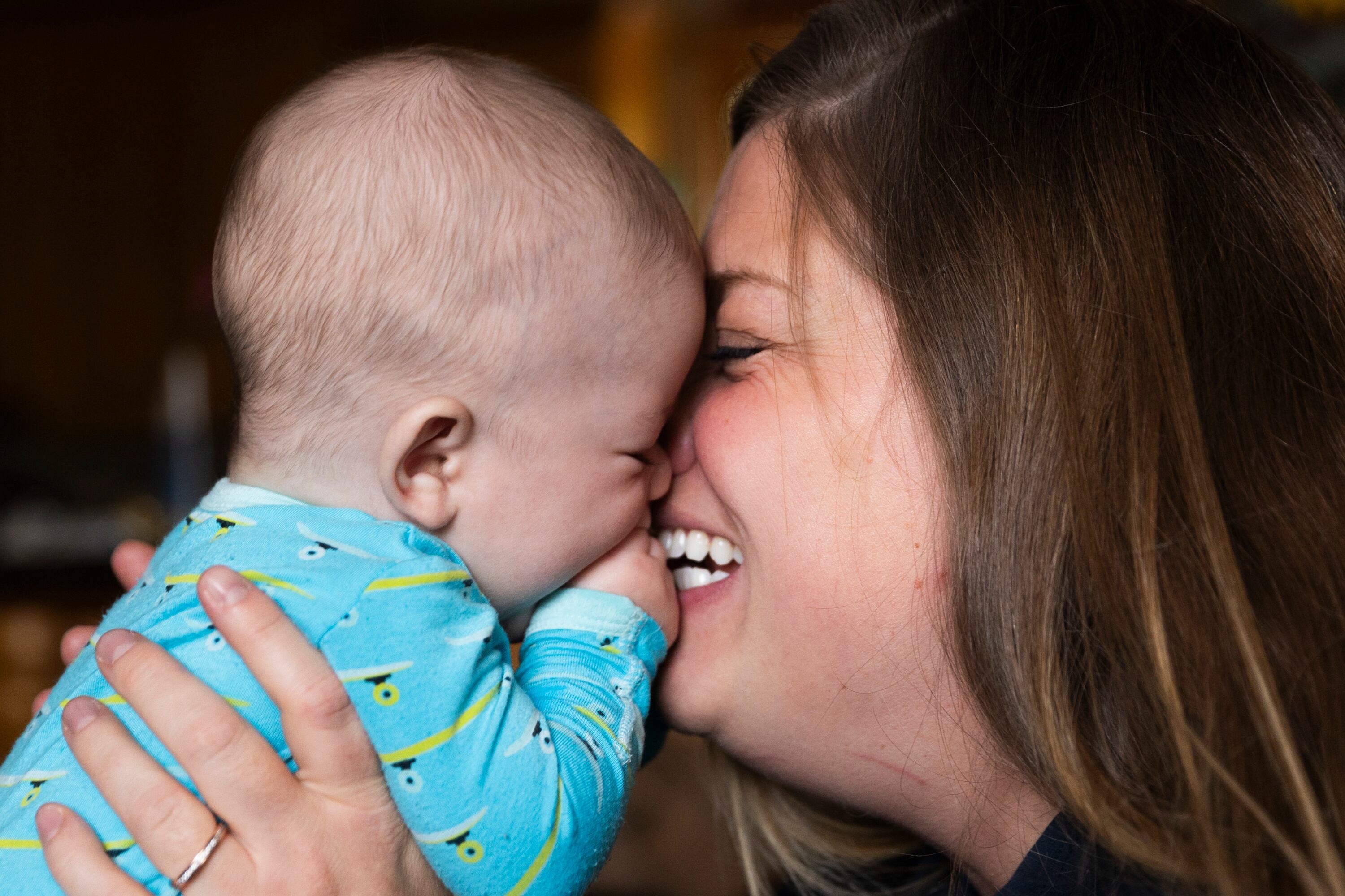 Four-month-old Edoardo Atzeni is kissed by his mother Nicole at their home in Salt Lake City, on May 8.