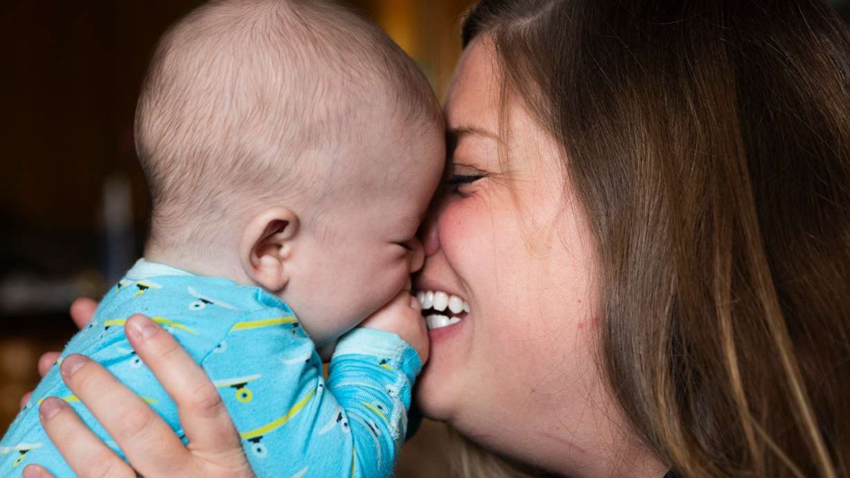Four-month-old Edoardo Atzeni is kissed by his mother Nicole at their home in Salt Lake City, on May 8.