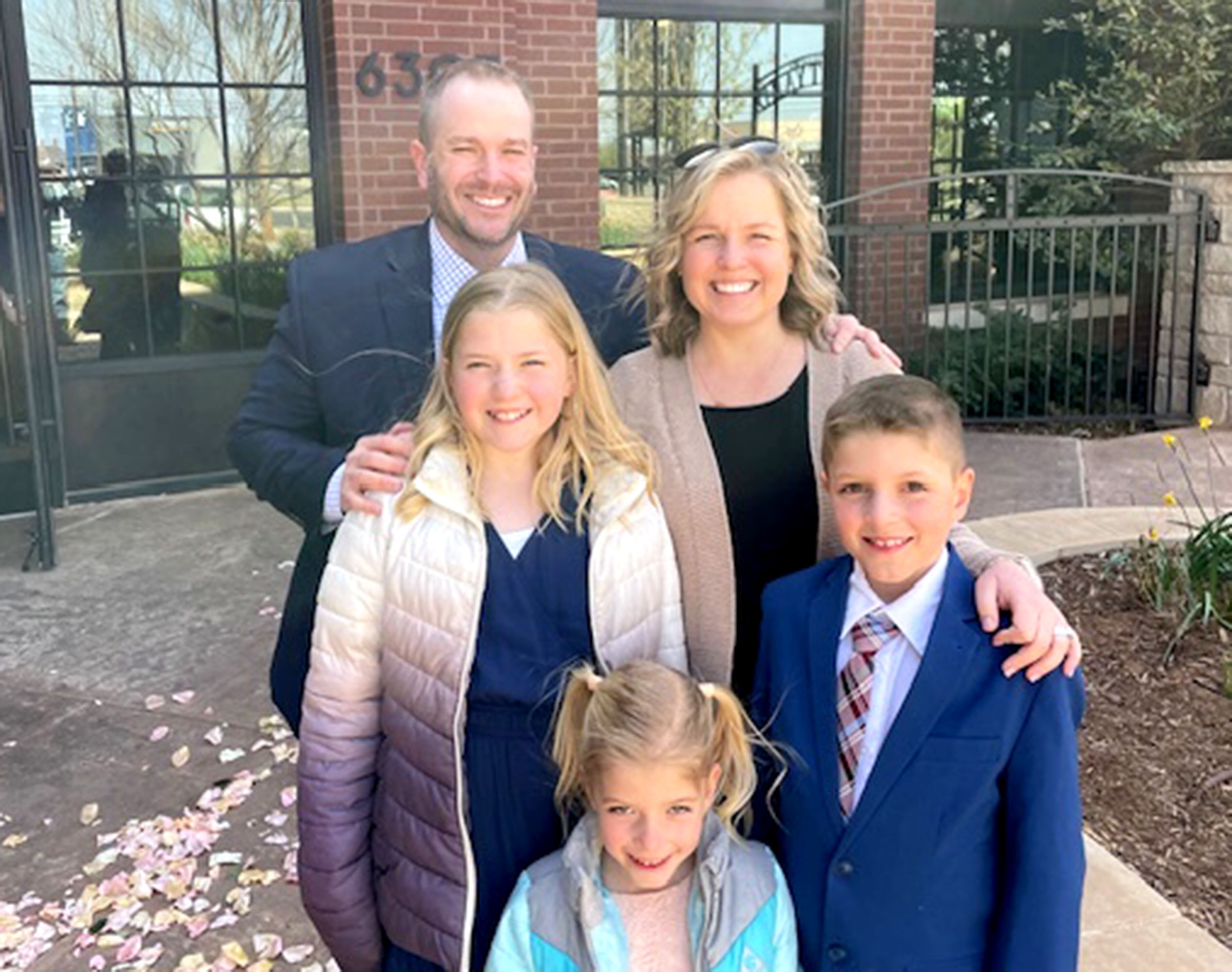 Mark Maines stands with Jaymie Maines, Haylee (13), McCoy (10), and Madyson (7). Jaymie and Mark Maines’ first child, James, was stillborn in October 2009, before these children were born.