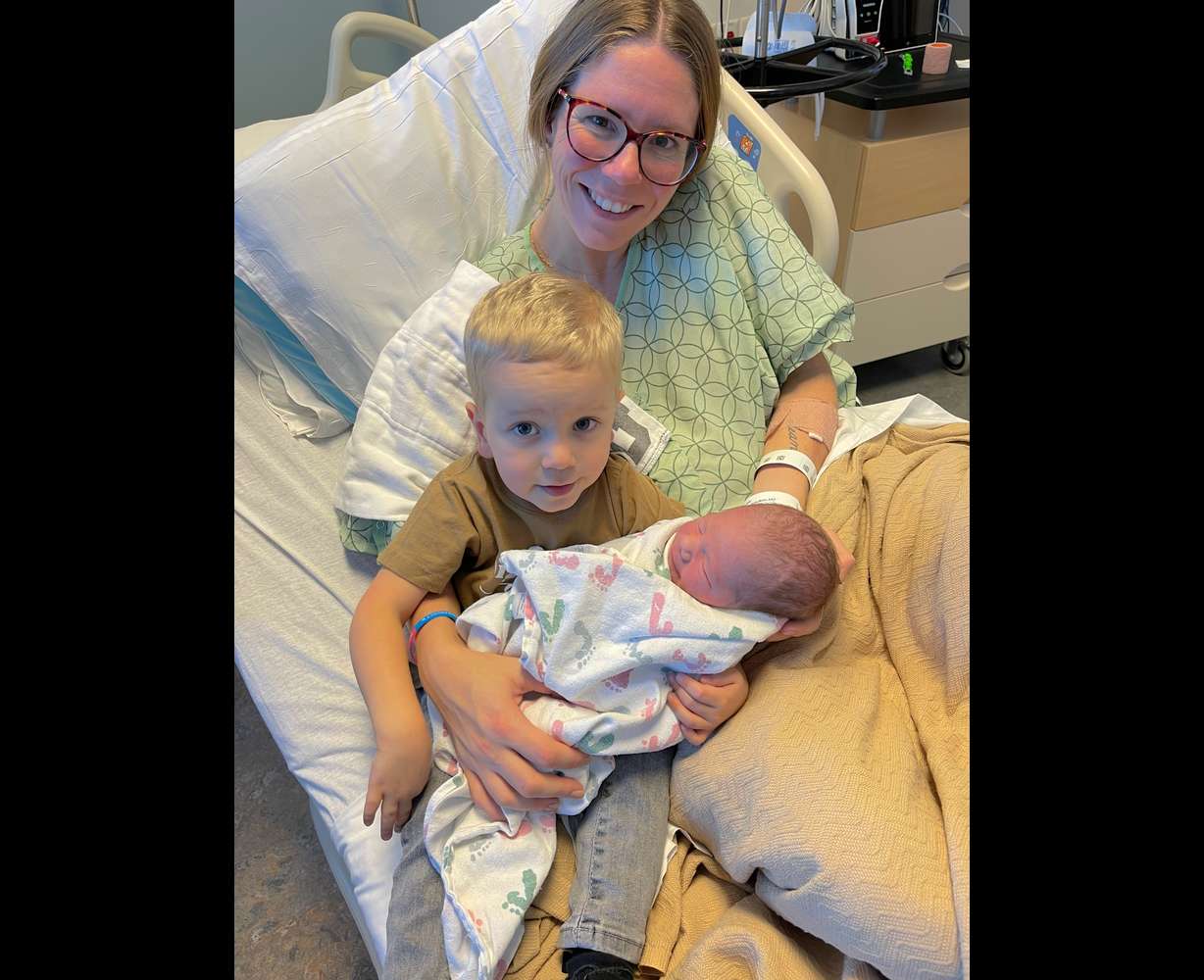 Emily Scott sits with her sons Colson and Elliott in this undated photo. She lost a baby at 31 weeks of pregnancy before Elliott was born.