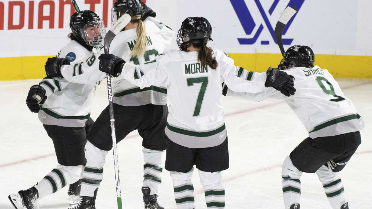 Boston's Taylor Wenczkowski, left, celebrates her goal against Montreal with Gigi Marvin (19), Sidney Morin (7) and Sophie Shirley (9) during the third overtime of a PWHL playoff hockey game in Laval, Quebec, Saturday, May 11, 2024.