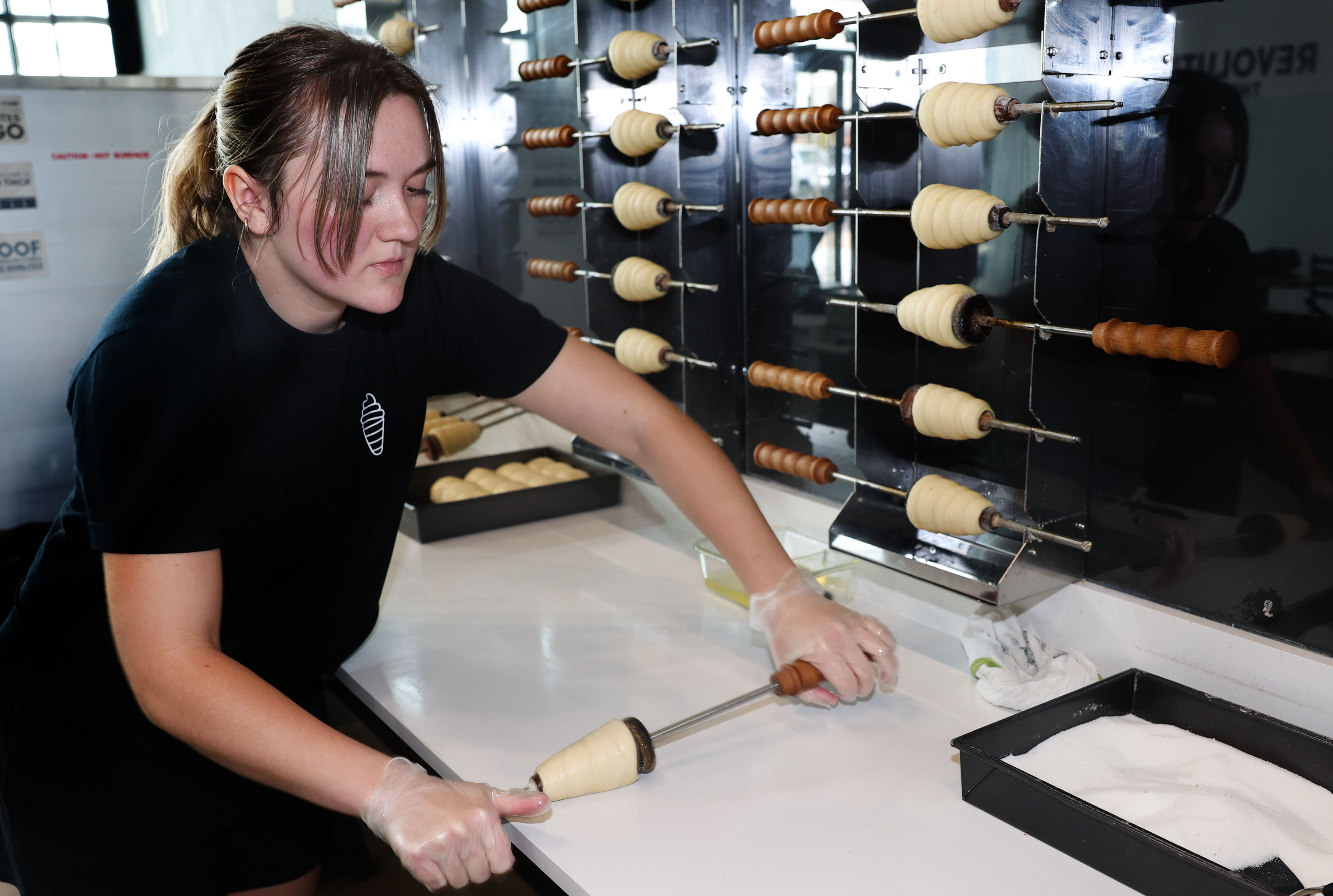 Shayna Heninger rolls a cone onto a dowel at Crispy Cones in Provo on  April 19.