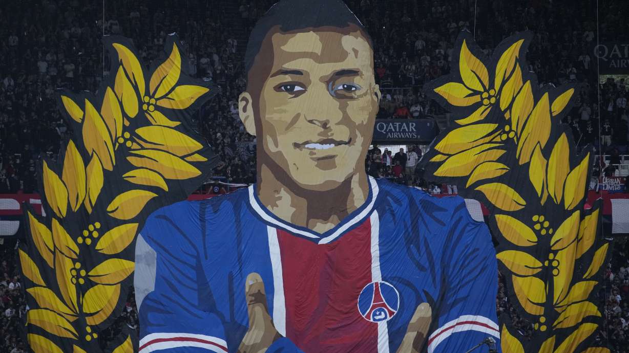 A giant painting depicting PSG's Kylian Mbappe is displayed before the French League One soccer match between Paris Saint-Germain and Toulouse at the Parc des Princes stadium in Paris, Sunday, May 12, 2024.