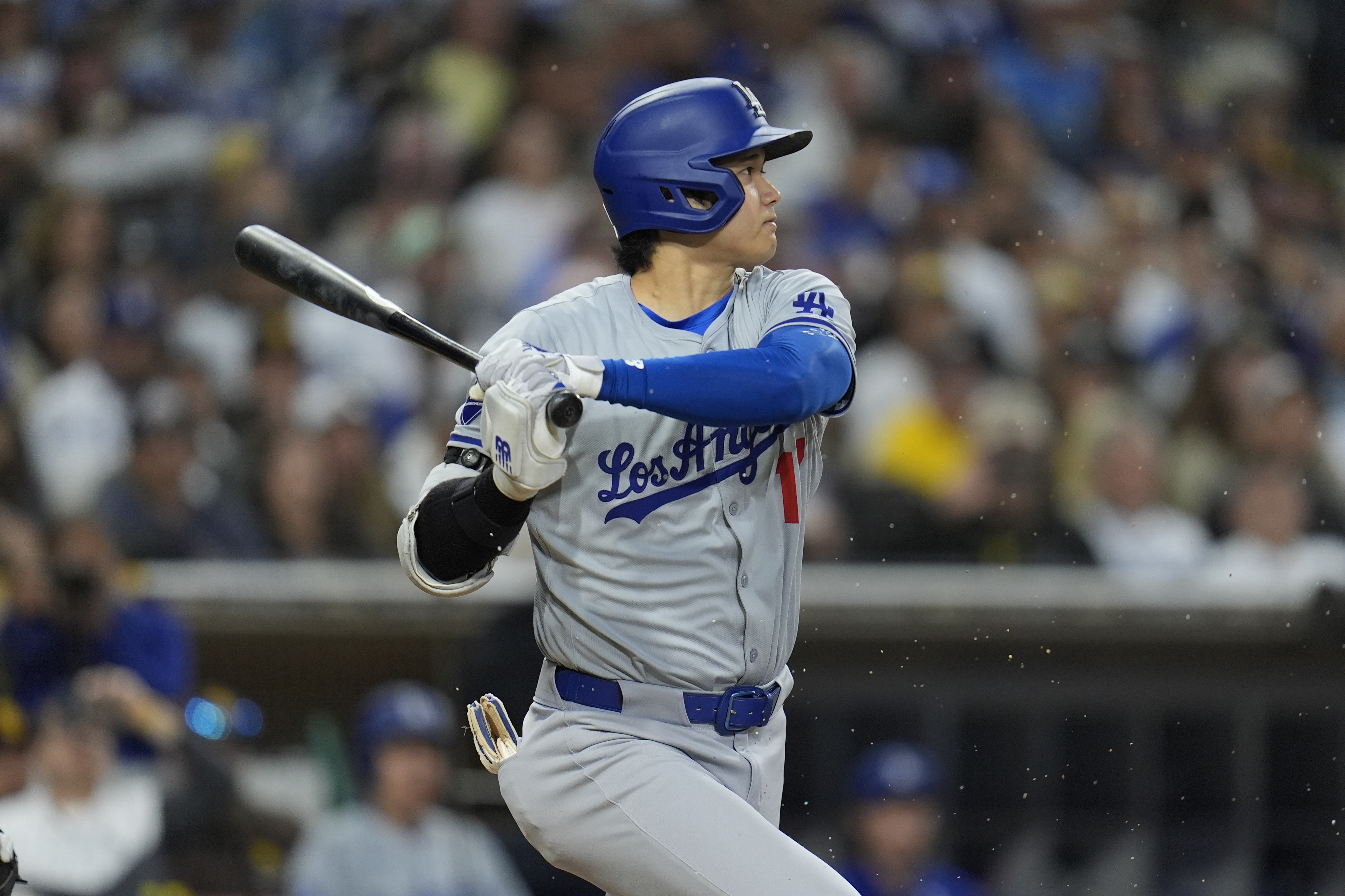 Los Angeles Dodgers' Shohei Ohtani watches his groundout during the seventh inning of a baseball game against the San Diego Padres, Saturday, May 11, 2024, in San Diego. 