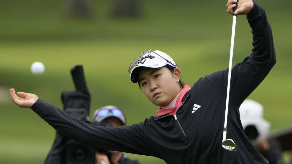 Rose Zhang loses her balance as she hits out of the rough on the first hole during the final round of the LPGA Cognizant Founders Cup golf tournament, Sunday, May 12, 2024, in Clifton, N.J.
