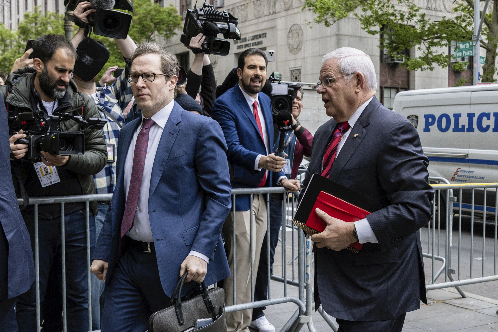 Sen. Bob Menendez, D-N.J., right, arrives for the first day of his trial at Manhattan federal court, Monday in New York.
