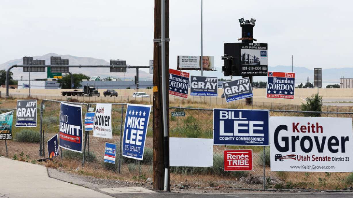 Campaign signs are displayed near I-15 in Orem on June 22, 2022. Campaign signs are starting to pop up on lawns, fences, and in some places that they shouldn't be.