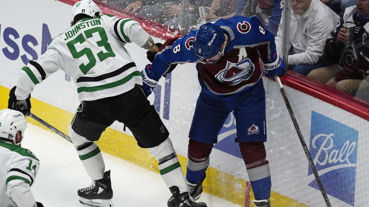 Dallas Stars center Wyatt Johnston (53) battles for control of the puck with Colorado Avalanche defenseman Cale Makar, right, in the first period of Game 4 of an NHL hockey Stanley Cup playoff series Monday, May 13, 2024, in Denver.
