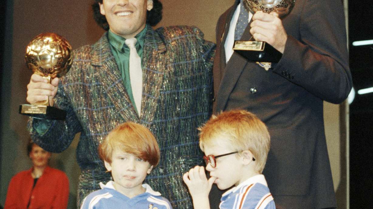 FILE - Argentina's soccer star Diego Maradona, left, and West German goalkeeper Harald Schumacher are holding their World Cup Soccer Ball awards while posing with two young soccer players during the Soccer Golden Shoe Award ceremony held in Paris, France, on Nov. 13, 1986. A trophy won by the late Diego Maradona for the best player at the 1986 World Cup that had mysterioulsy disappeared has resurfaced. It will be auctioned in Paris next month, the Aguttes house said on Tuesday May 7, 2024.